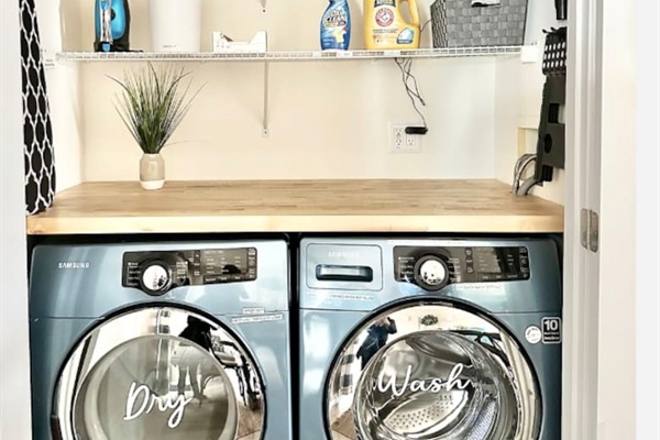 Enjoy the convenience of an in-home laundry nook featuring modern, high-efficiency Samsung front-load machines. Complete with a butcher block folding counter and overhead storage, making chores a breeze during your stay.