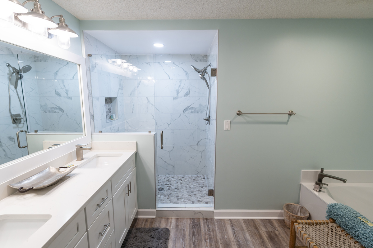 Walk-in shower and double vanity in the updated primary bathroom.