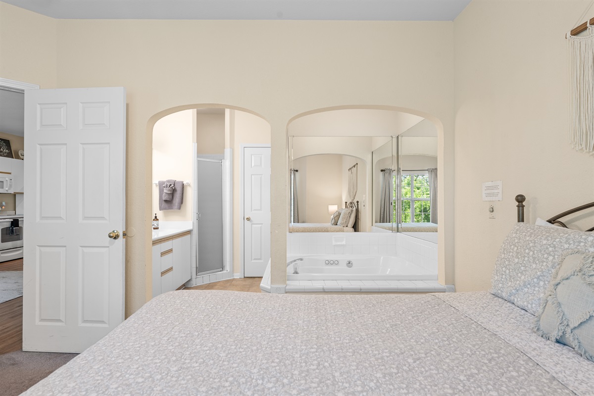 Alternate view of the primary suite, connecting the bedroom to the ensuite bath.