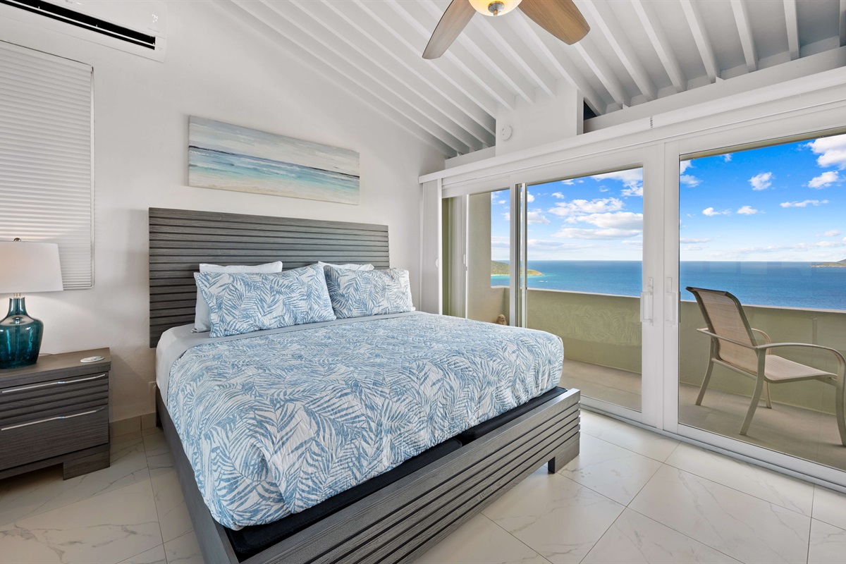 Primary king suite opens to a patio with seating