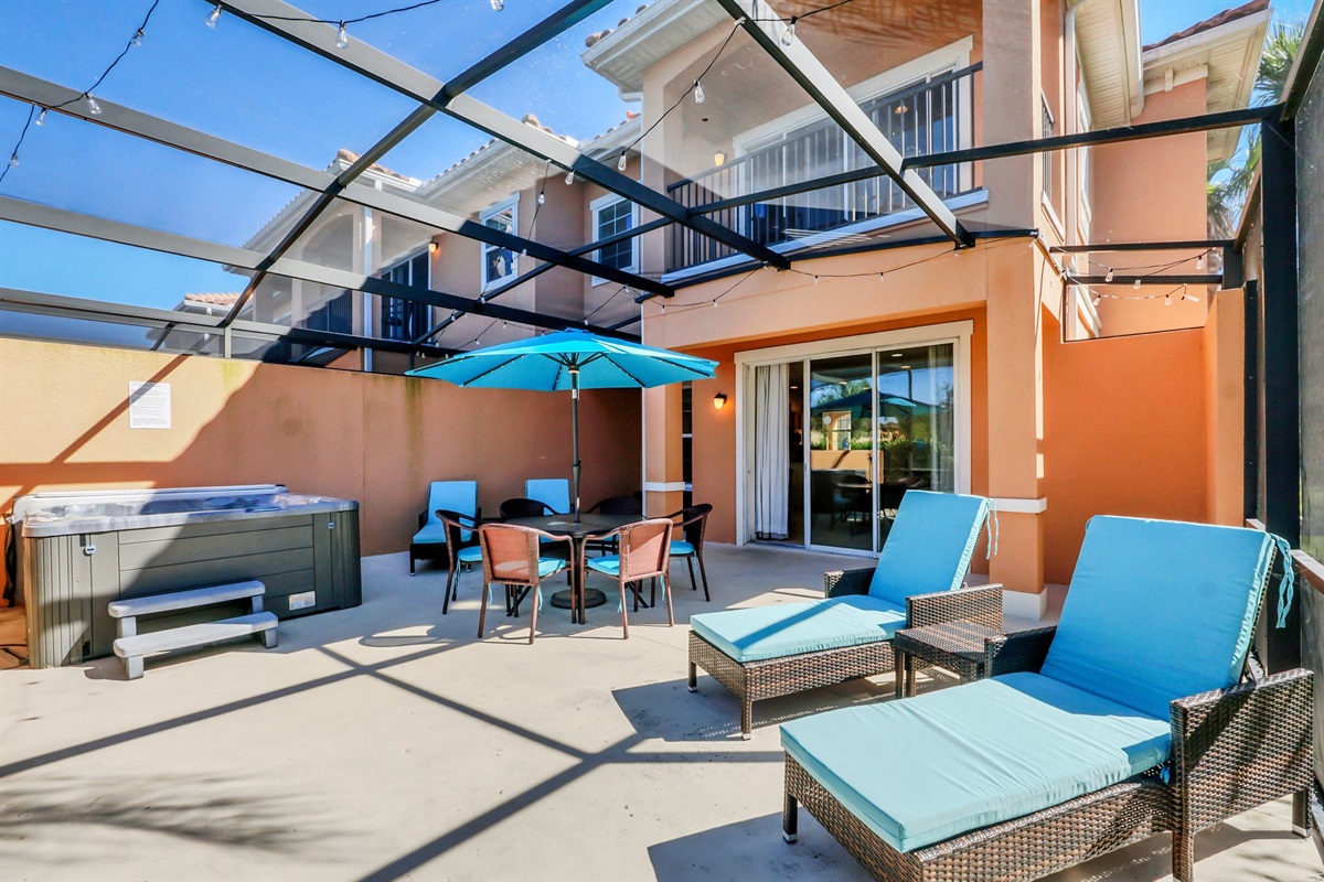 Private covered lanai with hot tub, dining area and lounge area