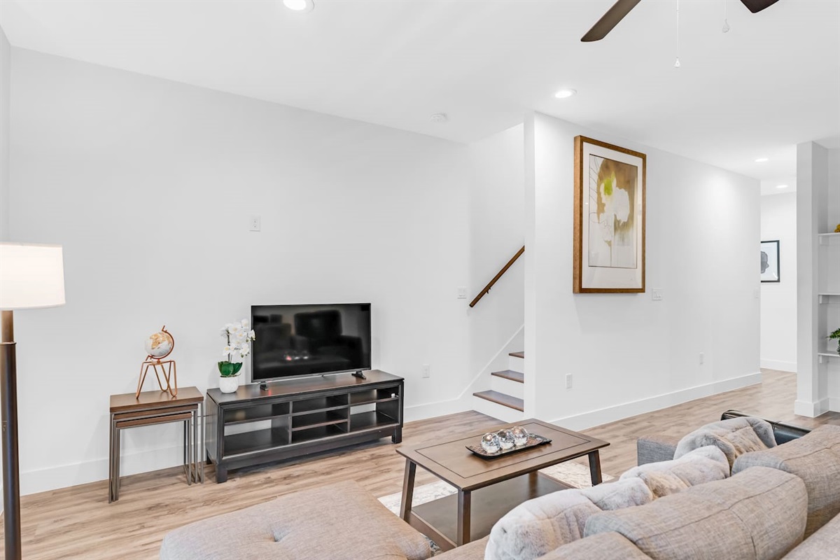Cozy living room featuring a flat-screen TV and stylish decor—ideal for relaxing movie nights after exploring the area.