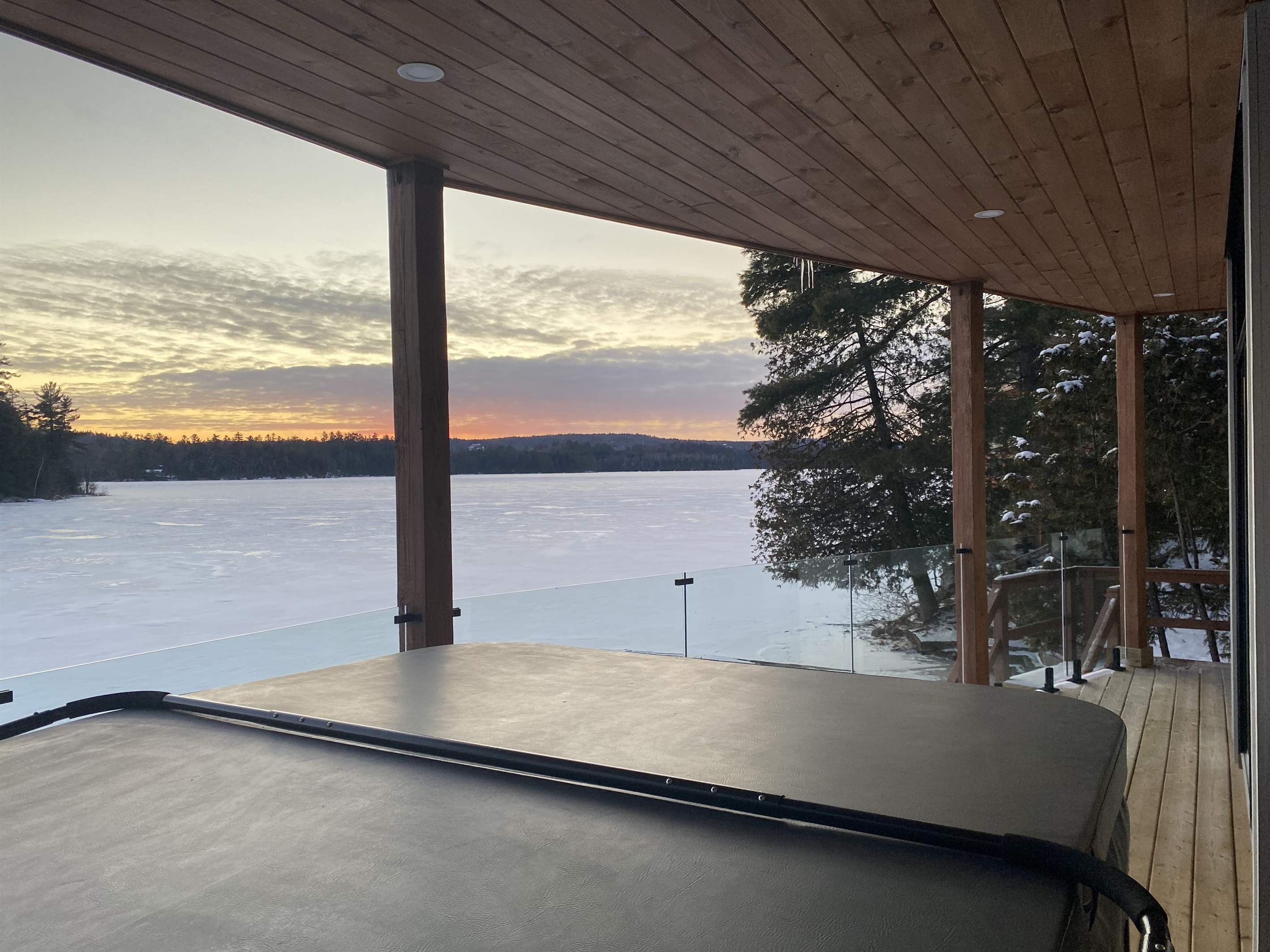 Lower balcony and hot tub with sunset in the western sky