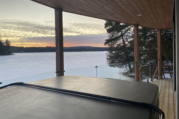 Lower balcony and hot tub with sunset in the western sky