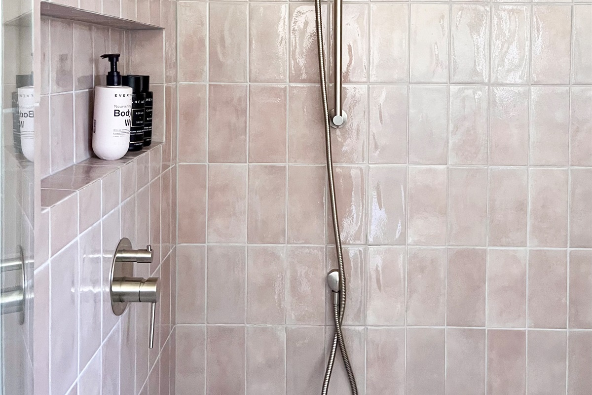 Soft light and neutral bathroom finishes create a calm, uncluttered outlook inside Summers Green View Retreat.