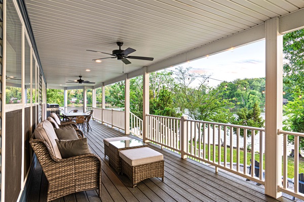 Cool comfort awaits on the covered porch. Take your pick – plush wicker rockers or the couch – as ceiling fans keep the breeze flowing.