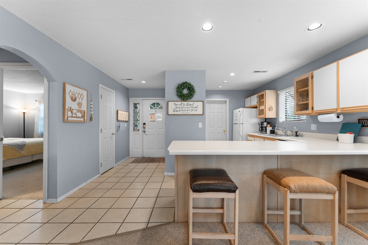 Bar seating keeps the kitchen social, so the cook is never cut off from the room.