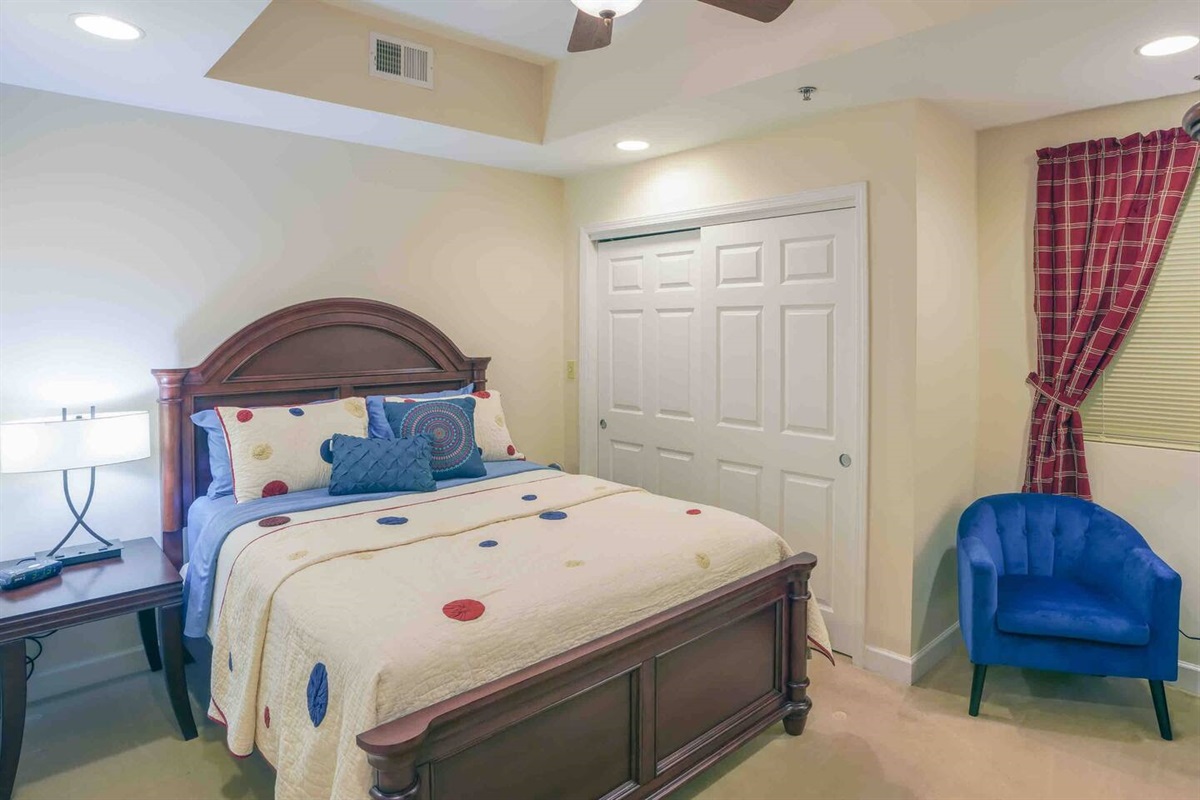 The second bedroom features a spacious closet and an extra seating area.