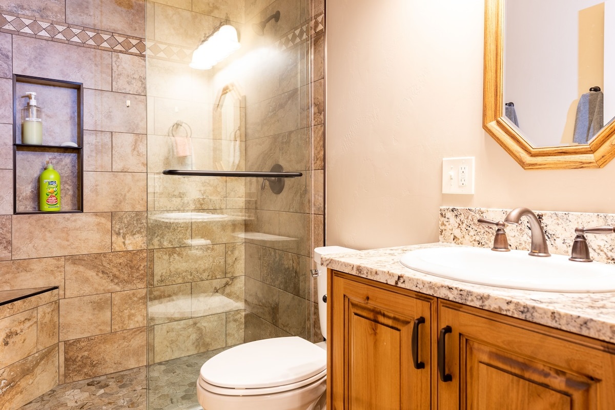 Enjoy the convenience of the basement walk-in shower that features beautiful tile work.