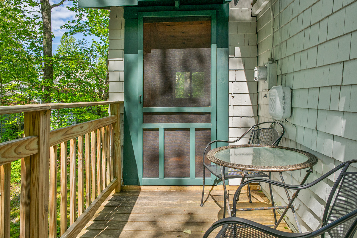 Step from the Pine Breeze Room to the side deck. This shaded, pet-friendly outdoor seating area features a table for two in lush summer greenery. Unwind in fresh island air and plan your hiking route before heading into Acadia National Park.
