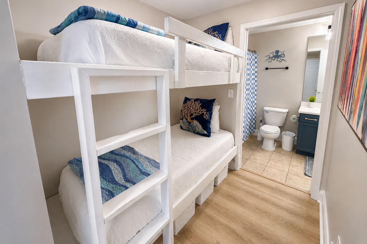 Bunk room with barn door and bathroom access