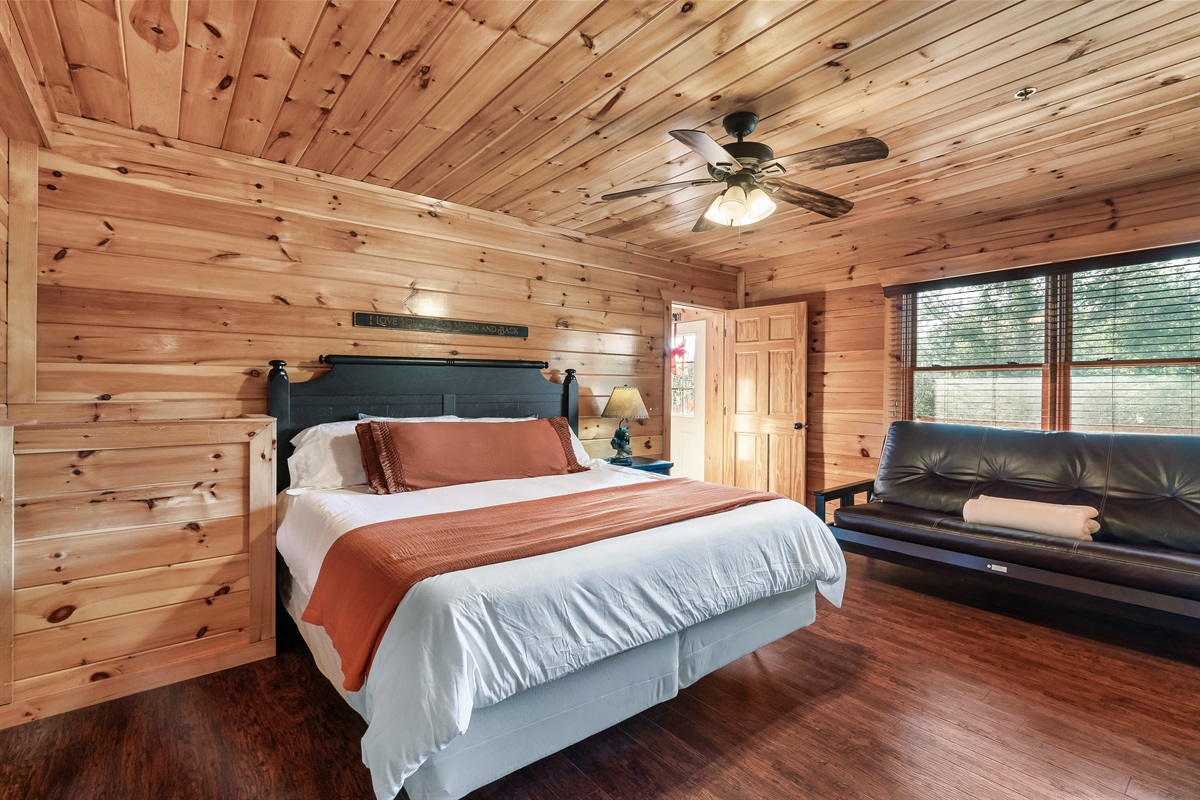 Retreat to a cozy queen bedroom where plush bedding and natural wood tones invite deep, restful sleep.