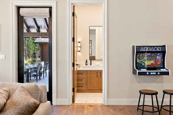 Bunk + game room with four built-in bunks, fireplace, lounge area and wall-mounted arcade