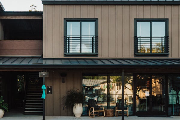 The Homestead Suite entry at Gaines Ranch on the Square &mdash; step-free ground-floor entry, ADA-accessible from the parking lot to the suite door.