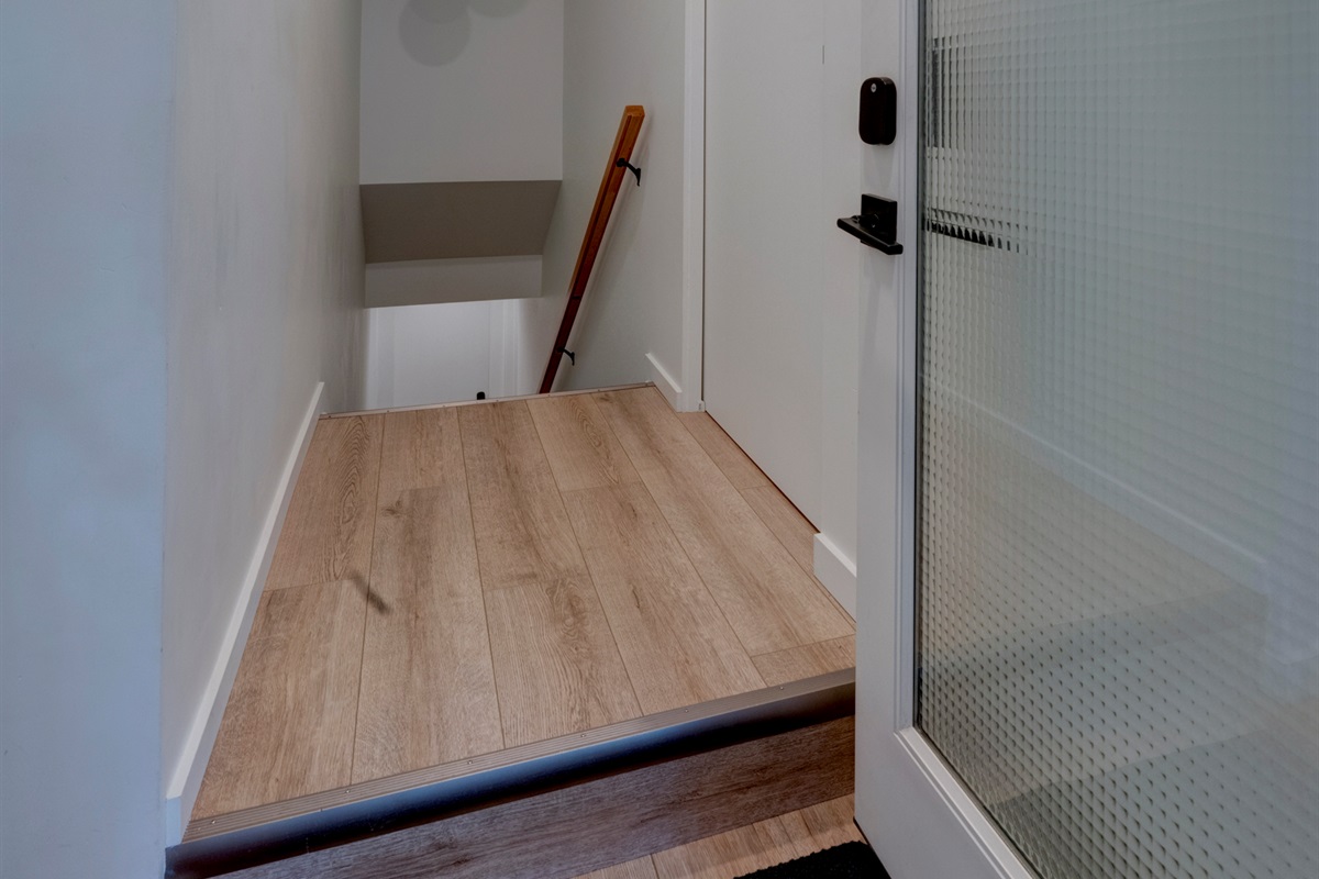 Stairway down to the suite — shoe storage is just inside the door to the left.