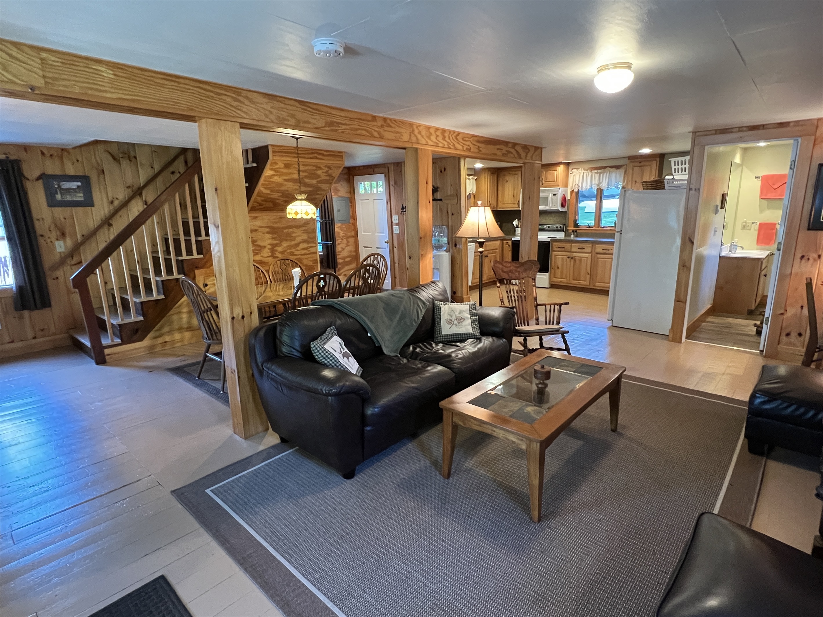 Downstairs area with open living, dining, kitchen and a full bath.