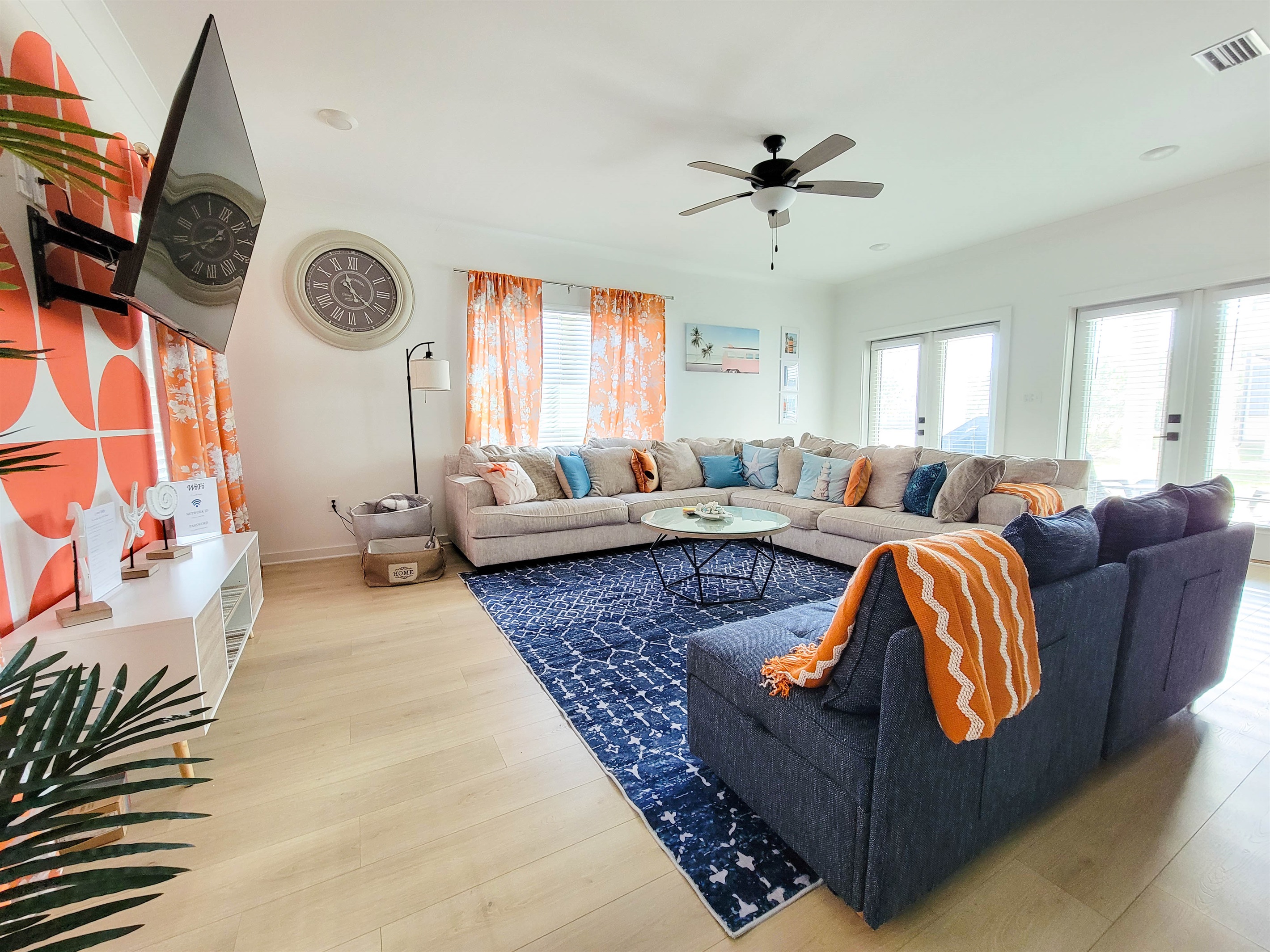 Another View of Living Room Where You Can See the Back Patio. Two Huge Glass Double Doors and Big Windows Invite a Lot of Natural Light into the Room