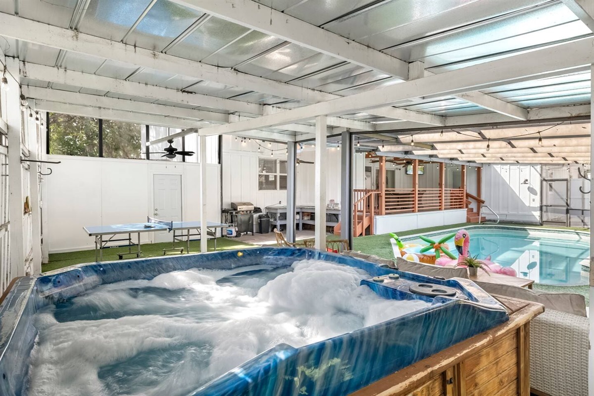 Covered and screened hot tub, ping pong, heated pool and patio. 
