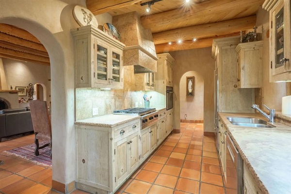 Kitchen with Bosch dishwasher, Sub-Zero refrigerator, 6 burner gas cooktop and oven.