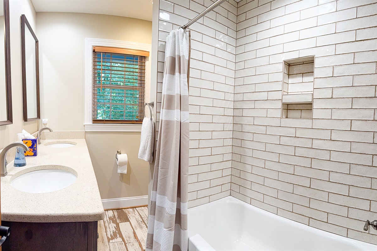 The upstairs bathroom includes a double vanity and a tub/shower combo for the upstairs bedrooms.