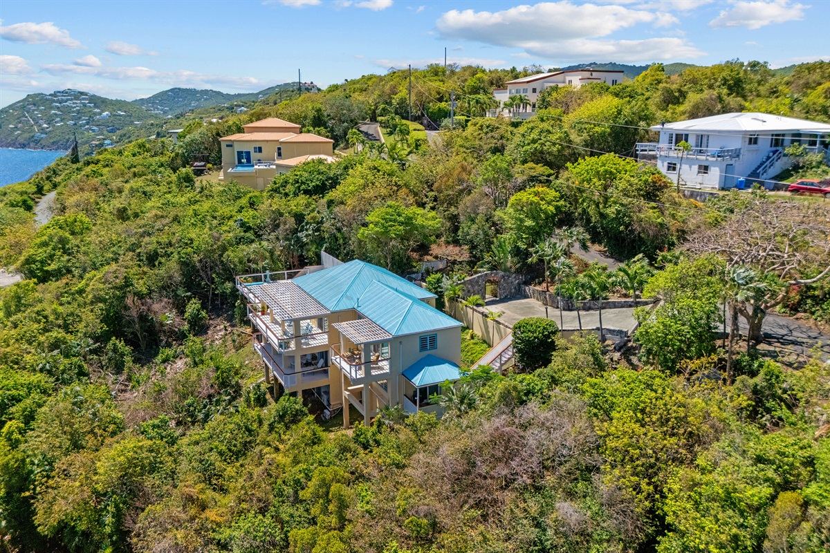 Pictured is the main house with the small blue roof on the lower left side where you completely separate living space is located. 
