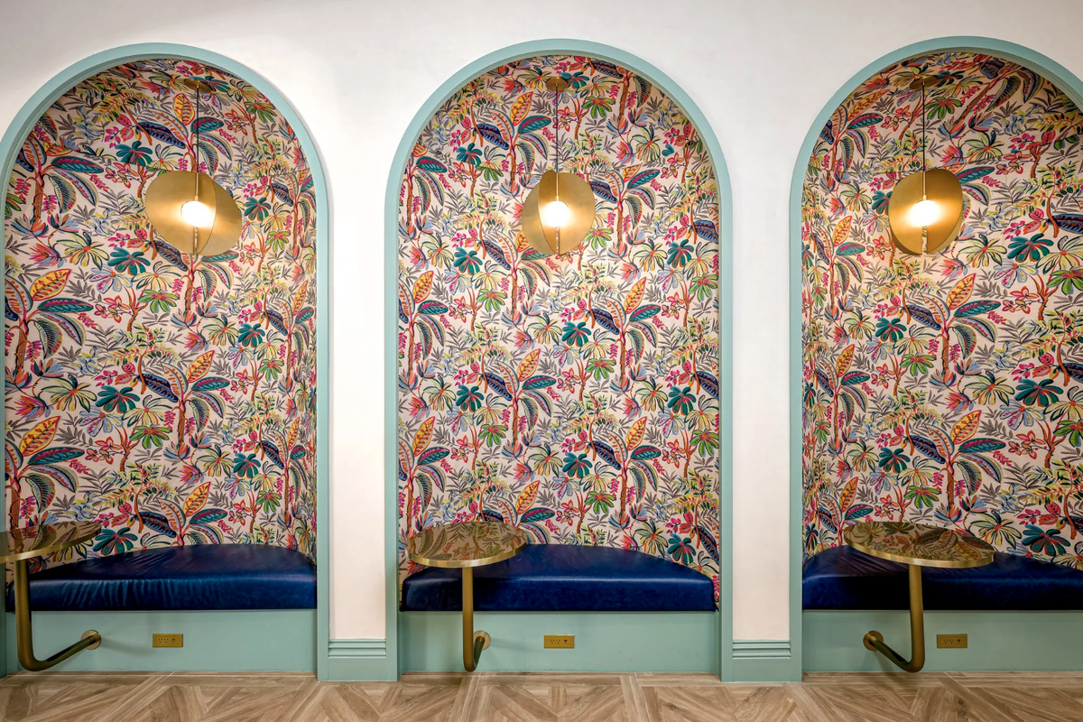 Intimate arched booths dressed in artisanal wallpaper - a designer setting for coffee, cocktails or conversation.