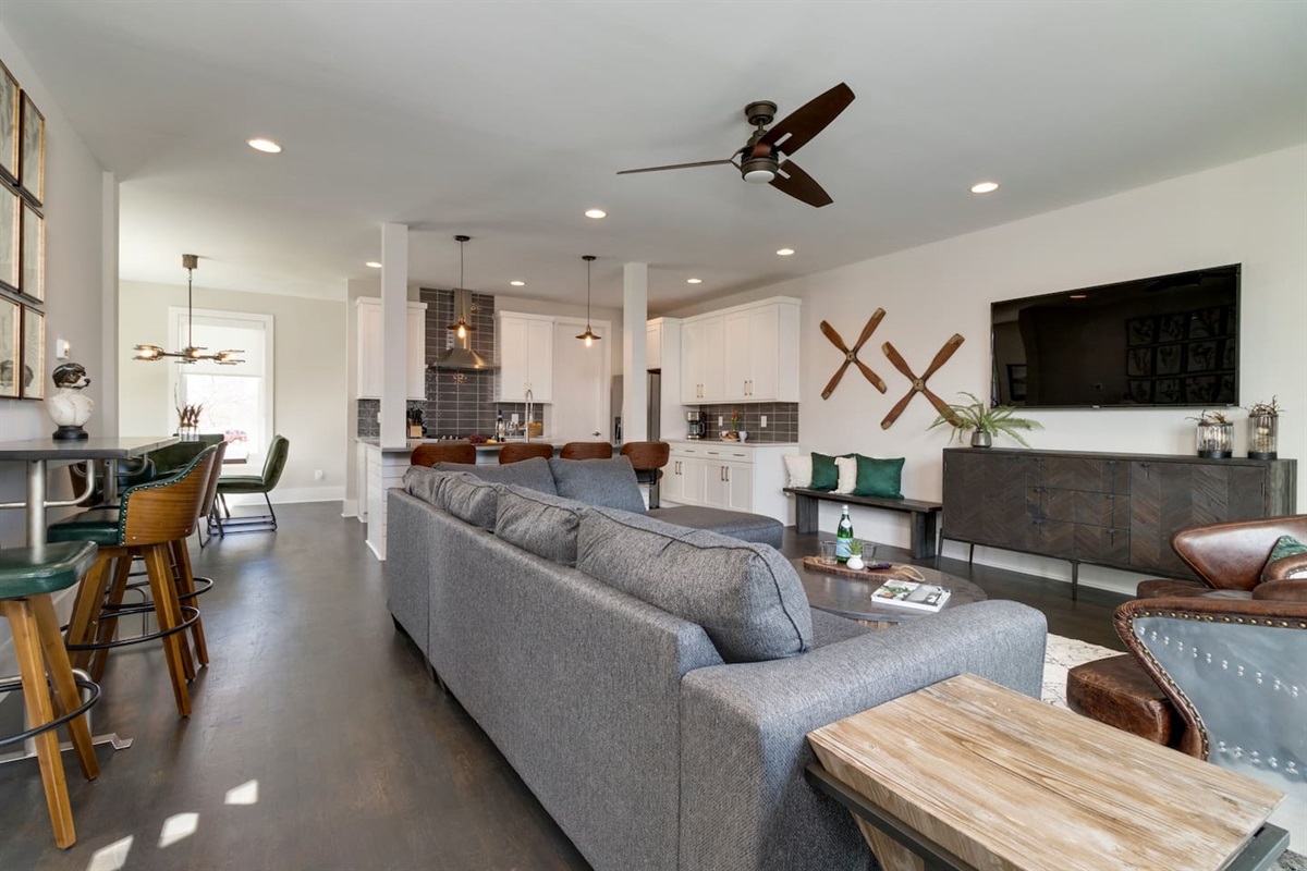 - Spacious layout with plush sectional, bar seating, and sleek kitchen all in one view - Modern ceiling fans, warm wood tones, and leather accents enhance the cozy vibe - Perfect for entertaining, relaxing, or enjoying movie nights with friends and family
