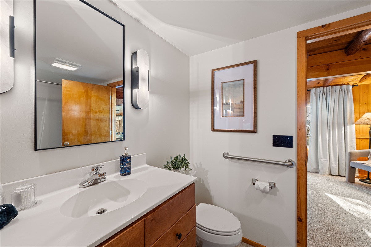 The large jack-n-jill bathroom has a full bathtub with shower. Support railing is also handy when needed.