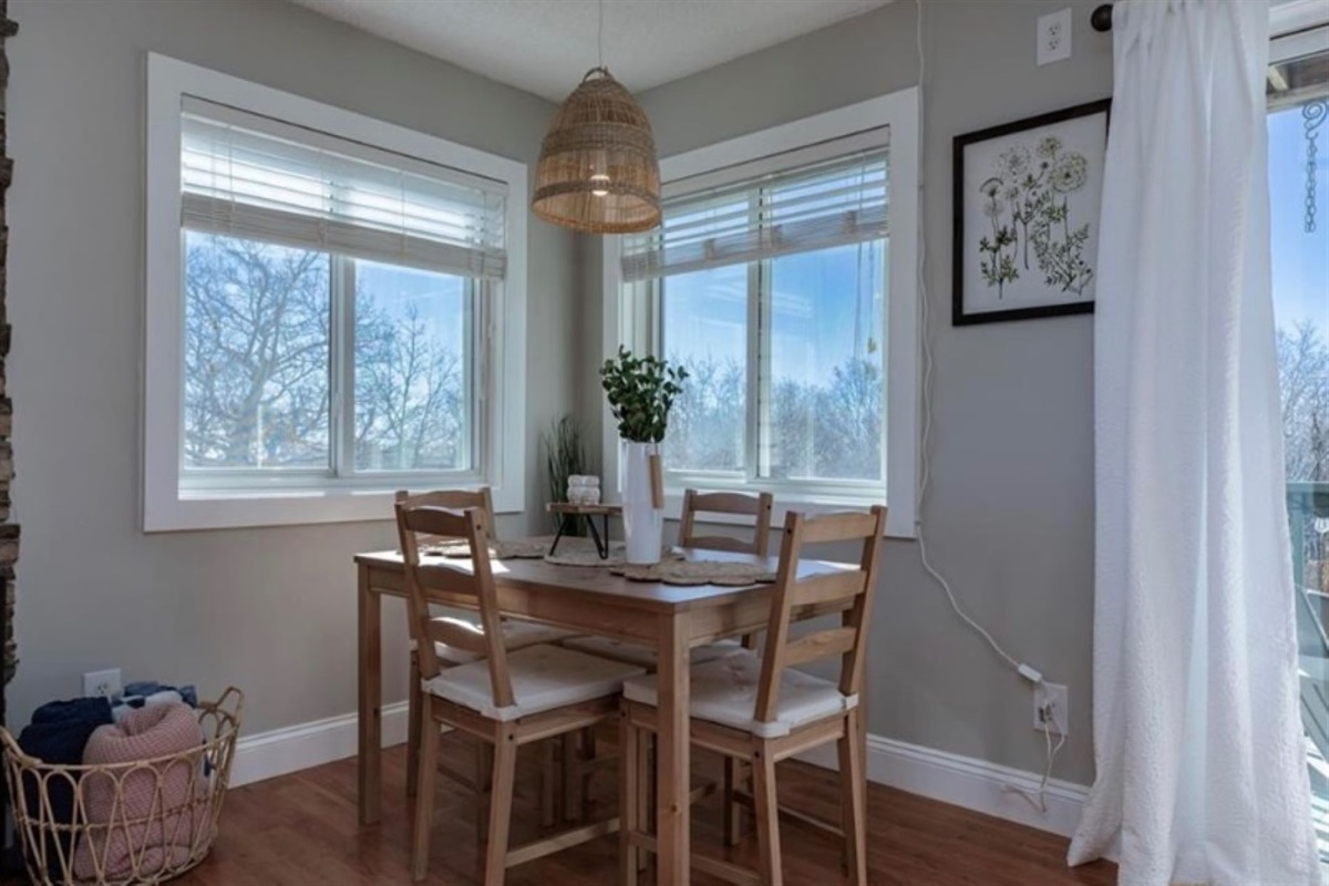 Dining area for four. Additional seating available on chairs and sofa with tray tables for dining.