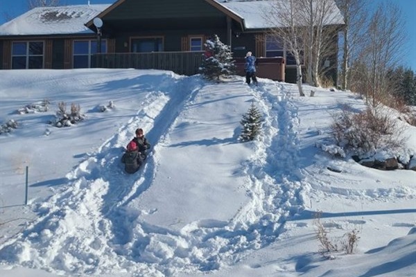 Kids sledding off the front of our home