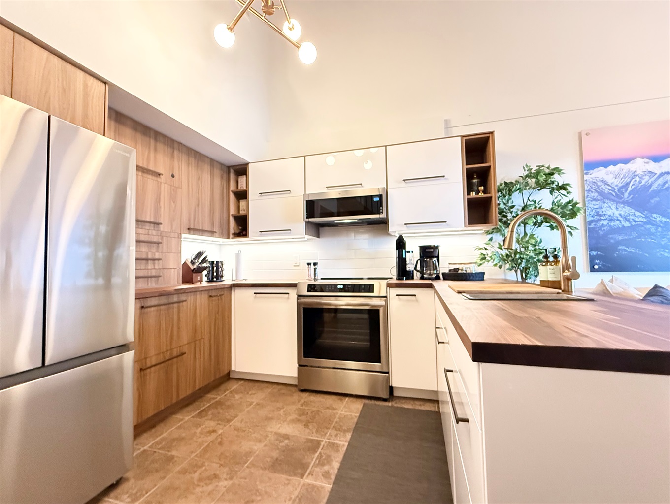 Fully Equipped Kitchen: Prepare delicious meals in this modern kitchen at your Kimberley rental, featuring a full-size french door fridge, induction range, and ample cabinet space for all your cooking needs.
