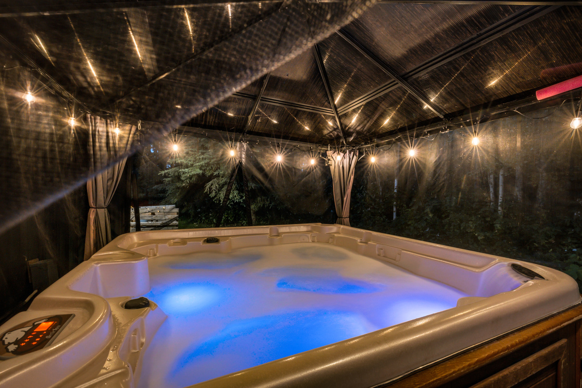 Turn on the lights, sink into the warm water, and let the day melt away in the hot tub under the covered gazebo.
