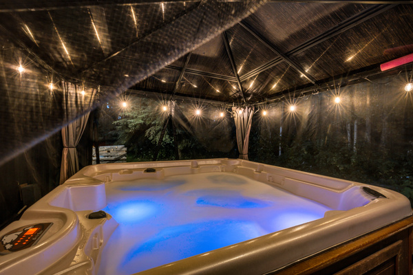 Turn on the lights, sink into the warm water, and let the day melt away in the hot tub under the covered gazebo.