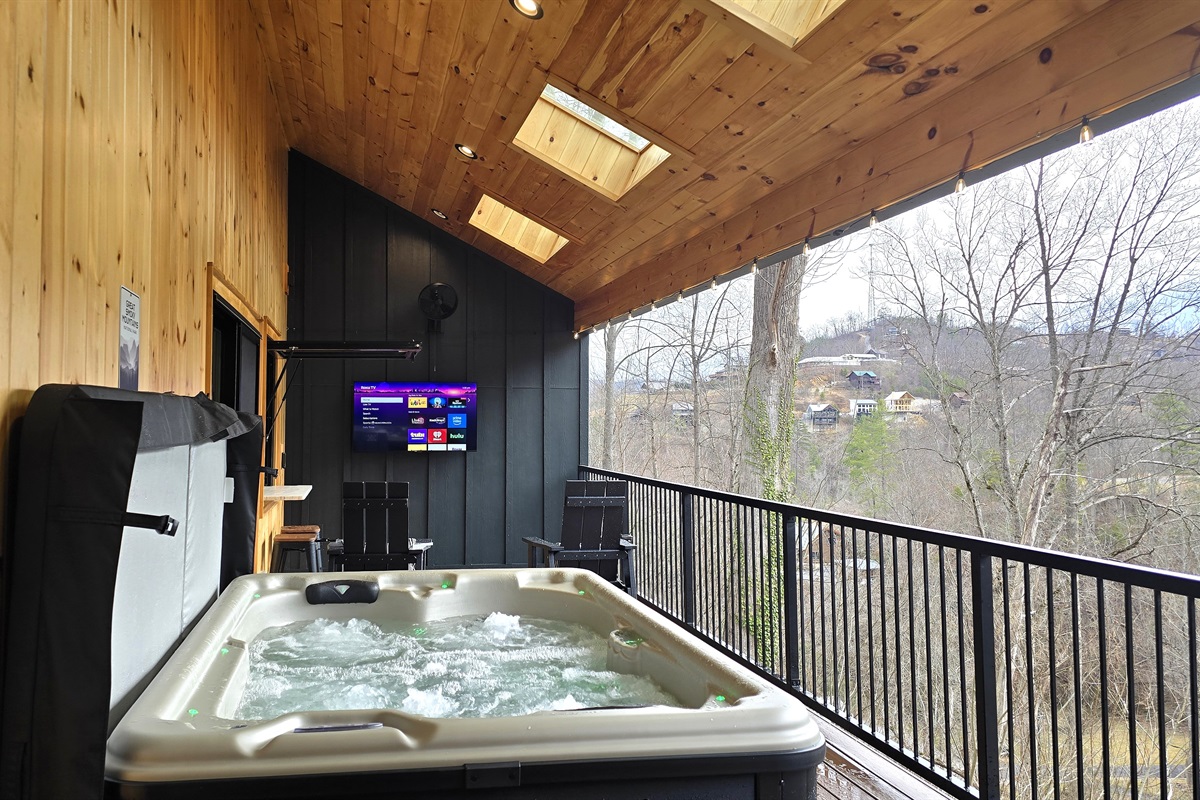 Enjoy a soak in the hot tub while watching TV