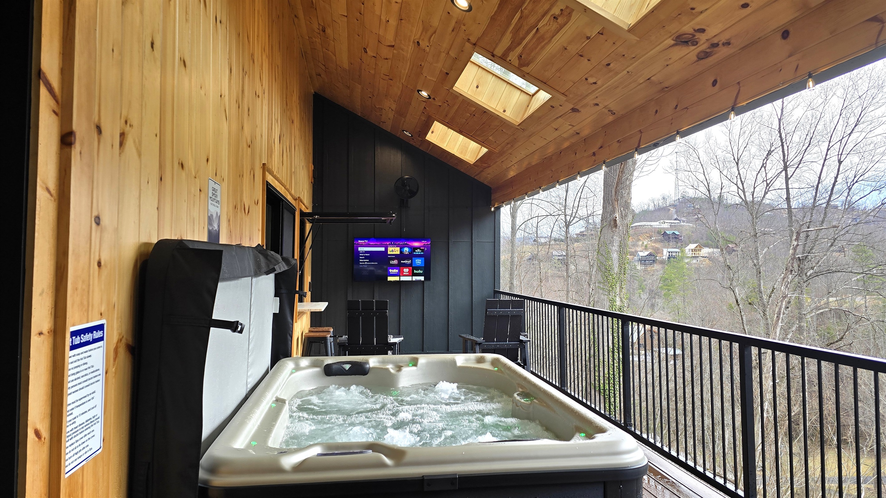 Enjoy a soak in the hot tub while watching TV