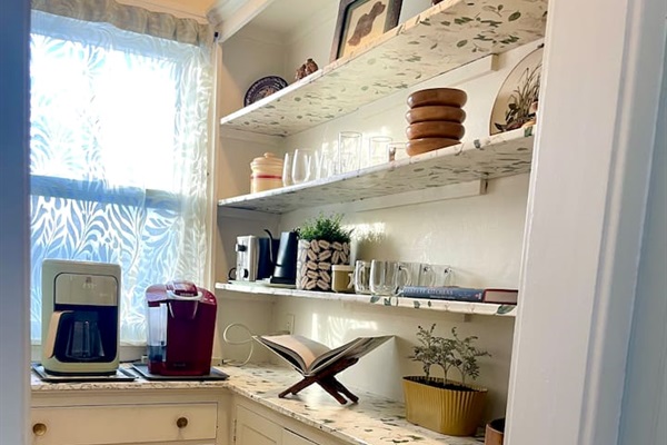 Cozy coffee station featuring a Keurig, drip coffee maker, toaster, and electric kettle—perfect for slow mornings.