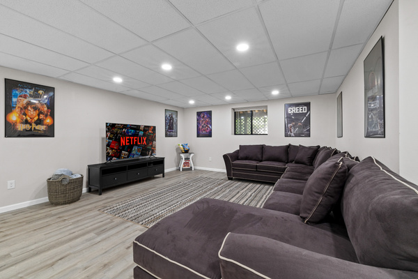 A movie-style smart TV and shelving to organize your other games