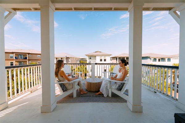 Enjoy morning coffee or sunset drinks on your private balcony with peaceful views of the charming beachside neighborhood. 