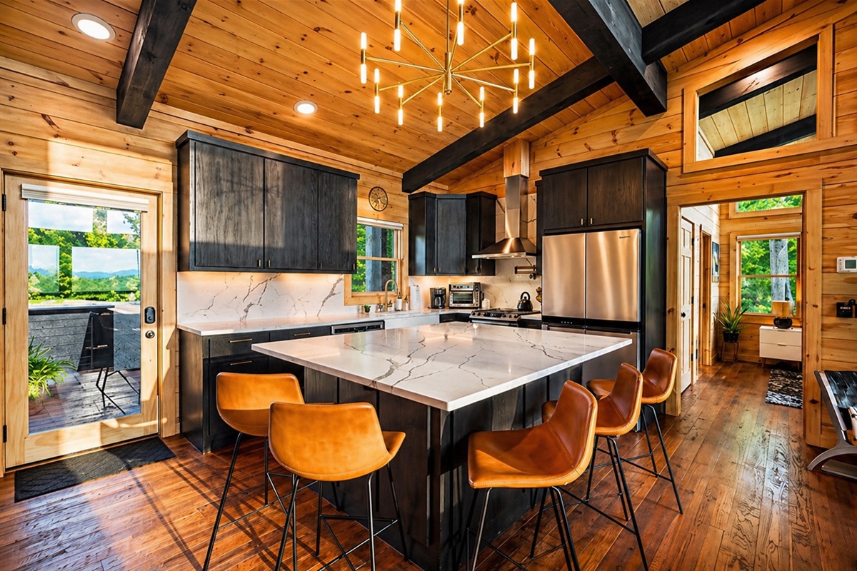 This sleek, modern kitchen with a large island is ideal for hosting and enjoying time with family and friends.