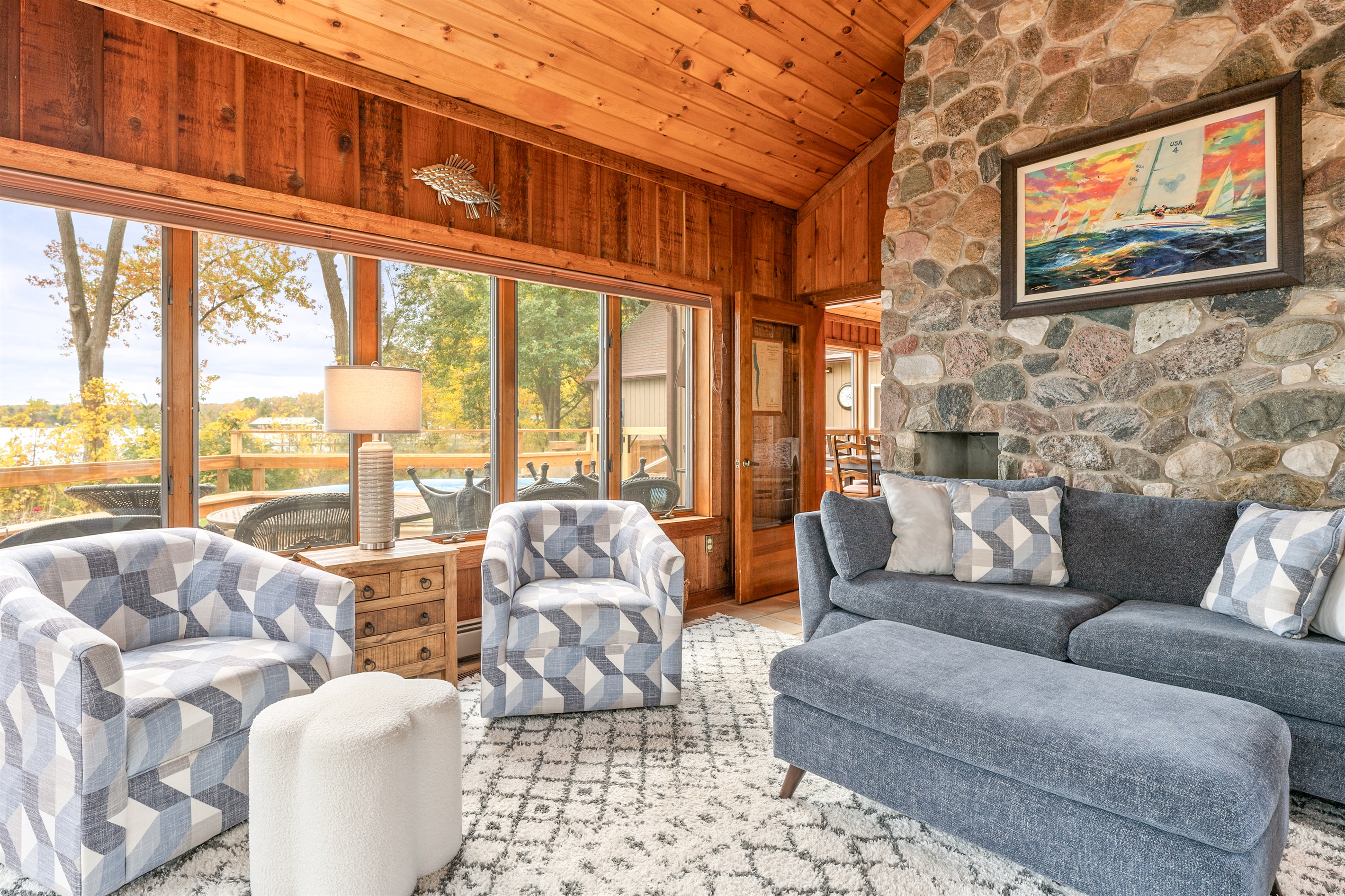 Charming stone fireplace meets lakeside relaxation in this inviting living room — unwind in true Finger Lakes fashion