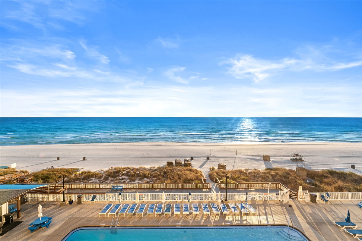 Your view from the balcony looks straight down to one of three pools and across to the beach and the sea.
