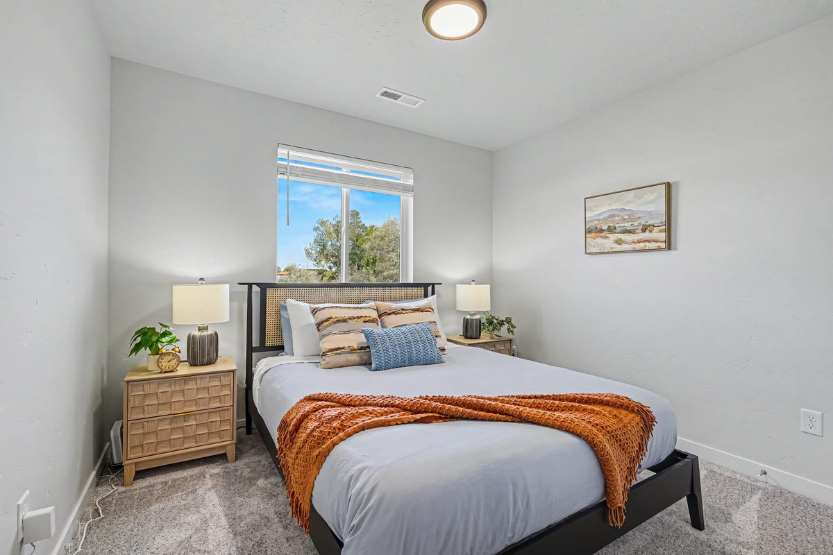 This downstairs bedroom features a comfortable Queen bed and plenty of room to relax, unwind, and enjoy a restful stay.