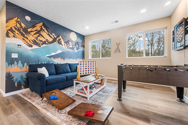The loft is the ultimate game hub, featuring an arcade with 15,000 games, a dartboard, giant Connect 4, mini cornhole, board games, and a foosball table—fun for all ages!