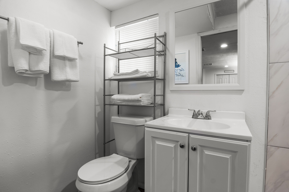 Modern bathroom vanity with extra linens.
