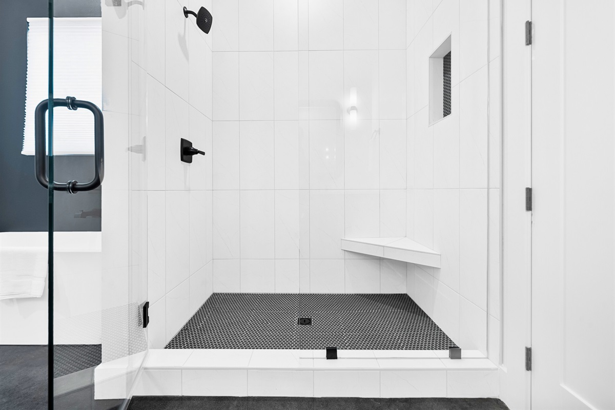 Bright and modern, this primary bathroom offers a spacious walk-in shower for a relaxing start or end to your day.