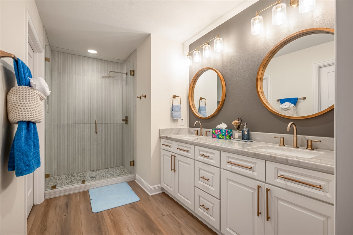 Another view of the spacious double-vanity bathroom with modern finishes.