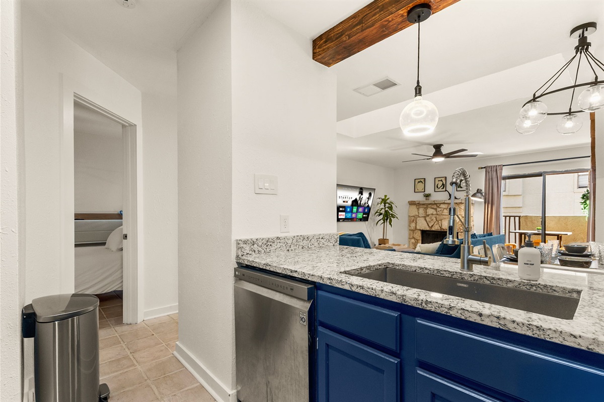 Kitchen featuring vibrant blue cabinets and generous counter space for cooking projects