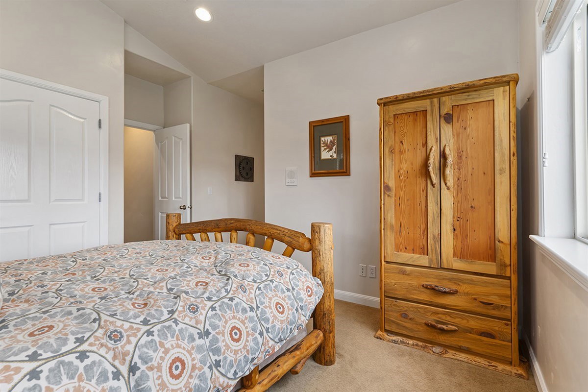 A well-appointed bedroom featuring ample storage and closet space, combining comfort and functionality for an effortless stay.