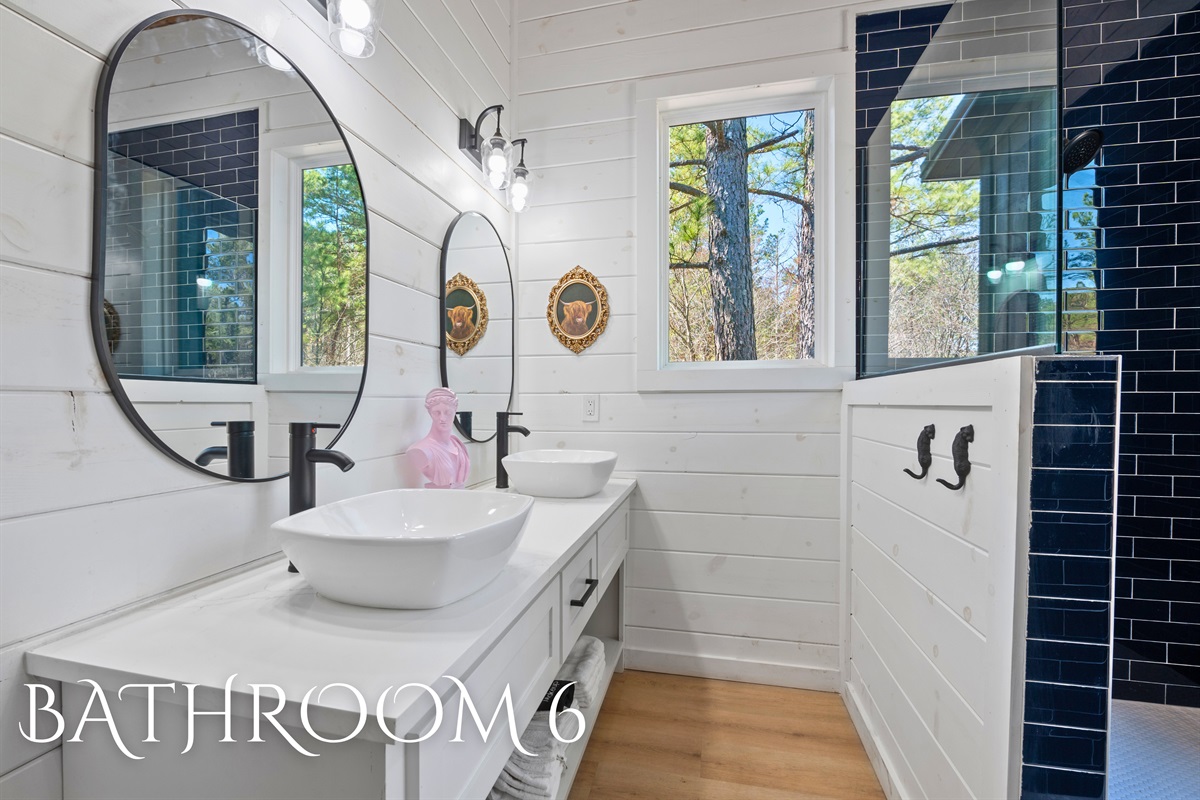 A beautifully designed bathroom featuring classic details, a fresh color palette, and plenty of counter space.