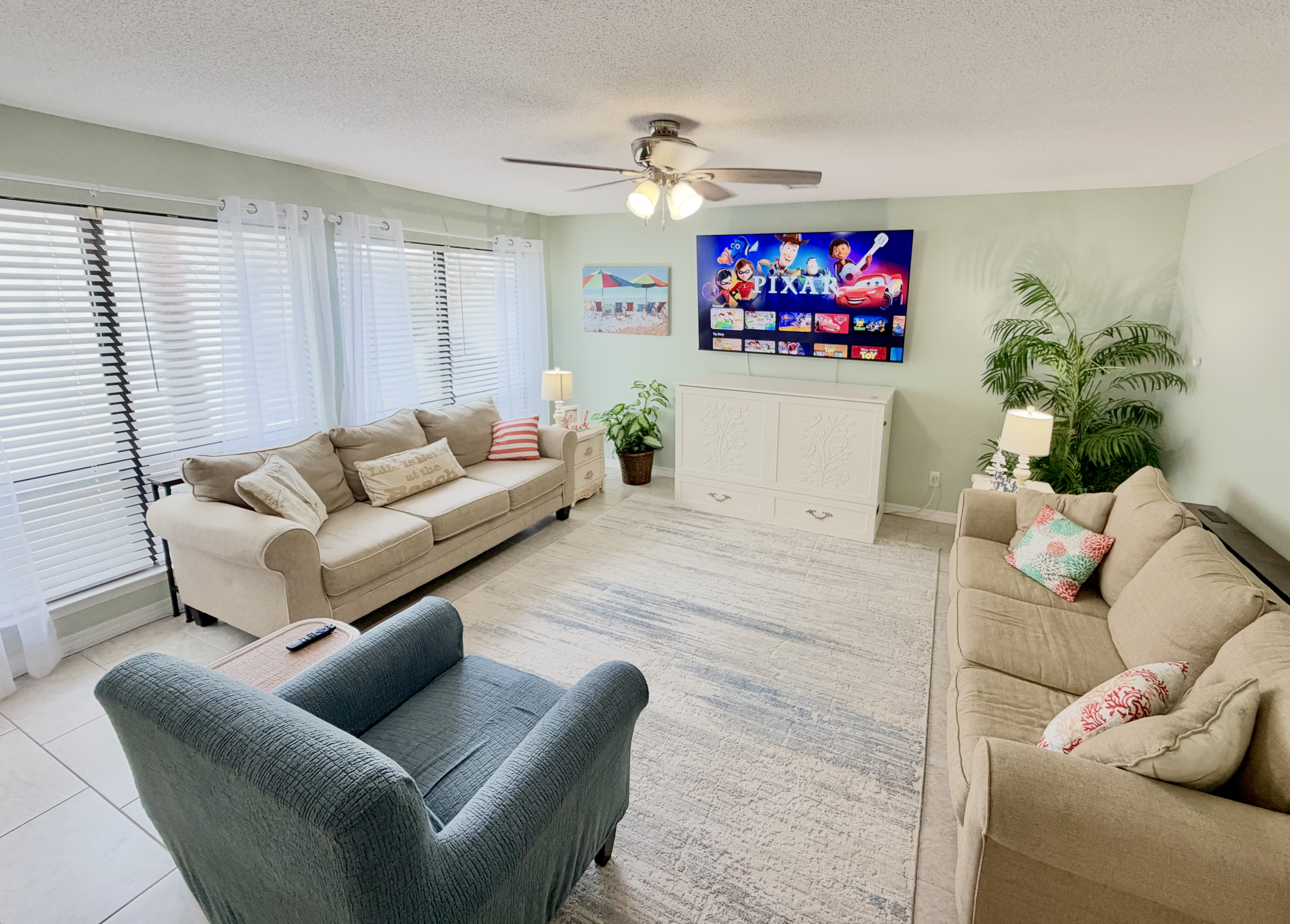 Open-concept living room complete with a 75" UHD Roku Smart TV. Bring those streaming credentials.